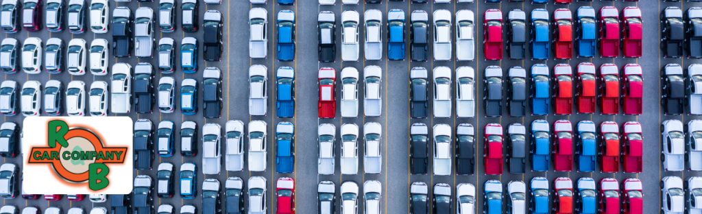 A customer speaking with a salesperson while reviewing used car options at a local dealership