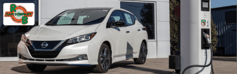 Nissan SUV parked outside R&B Car Company South Bend dealership on a sunny afternoon in South Bend, Indiana.