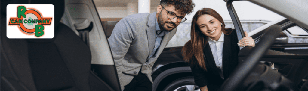  A happy customer in South Bend test driving an affordable sedan at R&B Car Company.