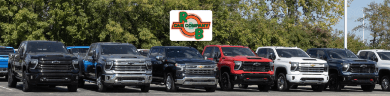 Customer browsing a row of used cars at R&B Car Company South Bend dealership lot.