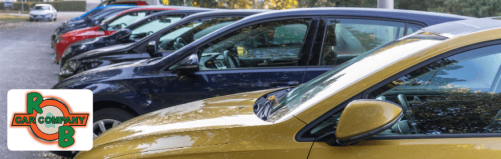 Customer browsing vehicles for sale at R&B Car Company South Bend showroom with assistance from a sales representative.
